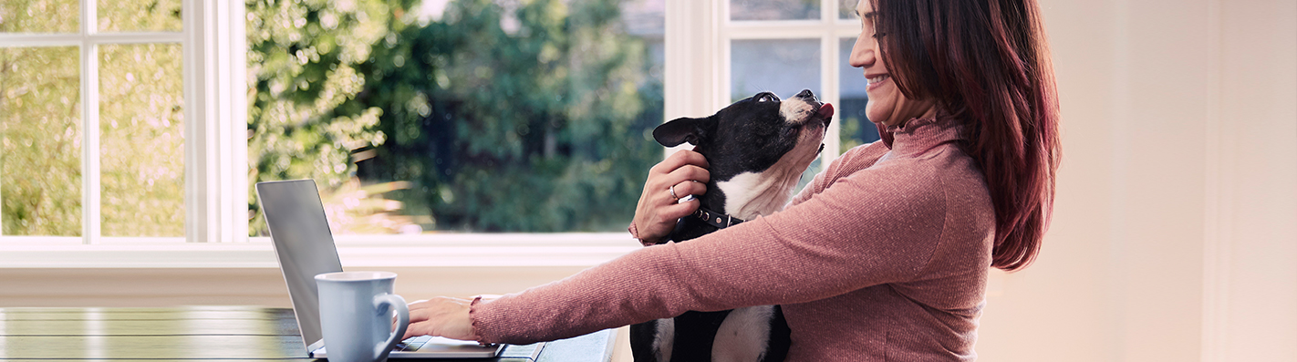 Woman getting a kiss from her dog